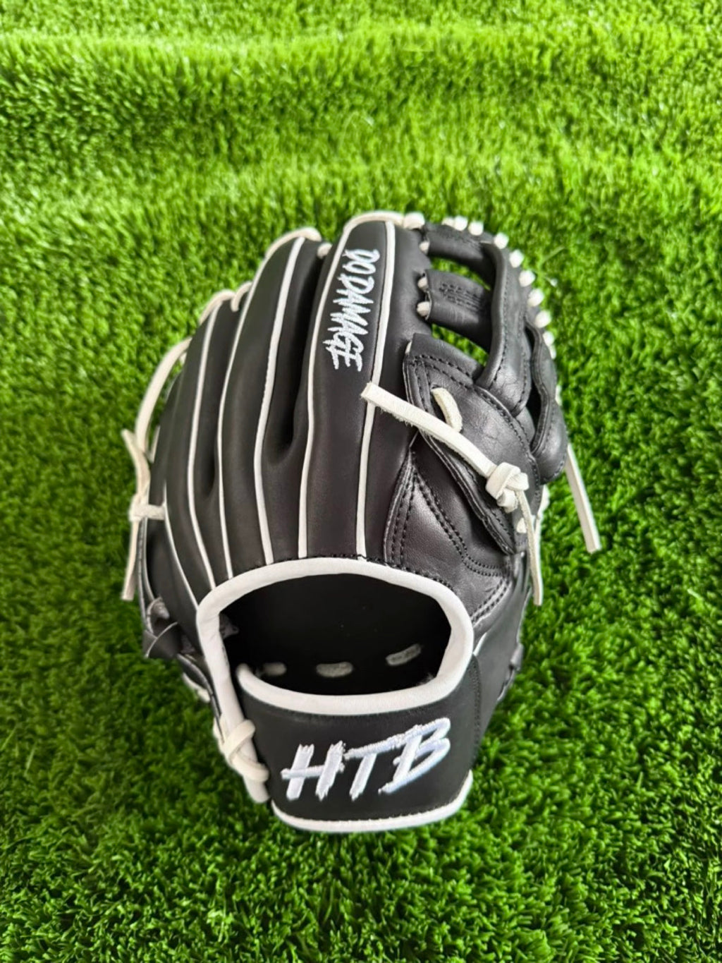 HTB Do Damage 11.75 inch infield glove, black and white, back view with DO DAMAGE and HTB embroidery