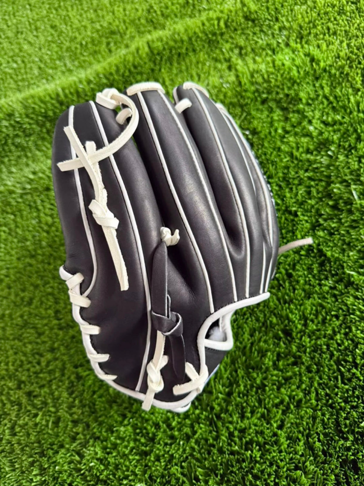 Black HTB Do Damage infield glove, finger view with white laces