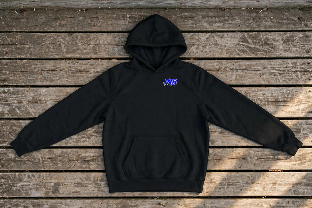 HTB Do Damage Hoodie in Black - front flat lay on a dugout bench
