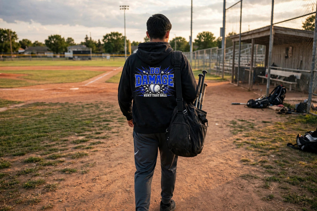 Blue Do Damage Hoodie lifestyle back - player walking to the field with bat bag