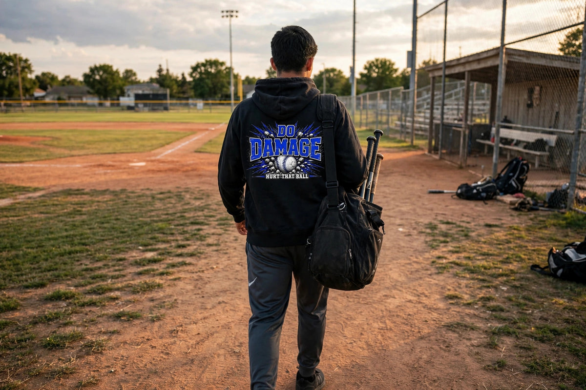 Blue Do Damage Hoodie lifestyle back - player walking to the field with bat bag