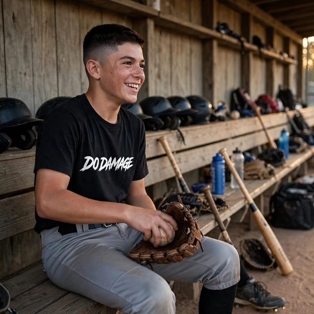 HTB Do Damage OG Tee - player working a ball into his glove on the dugout bench