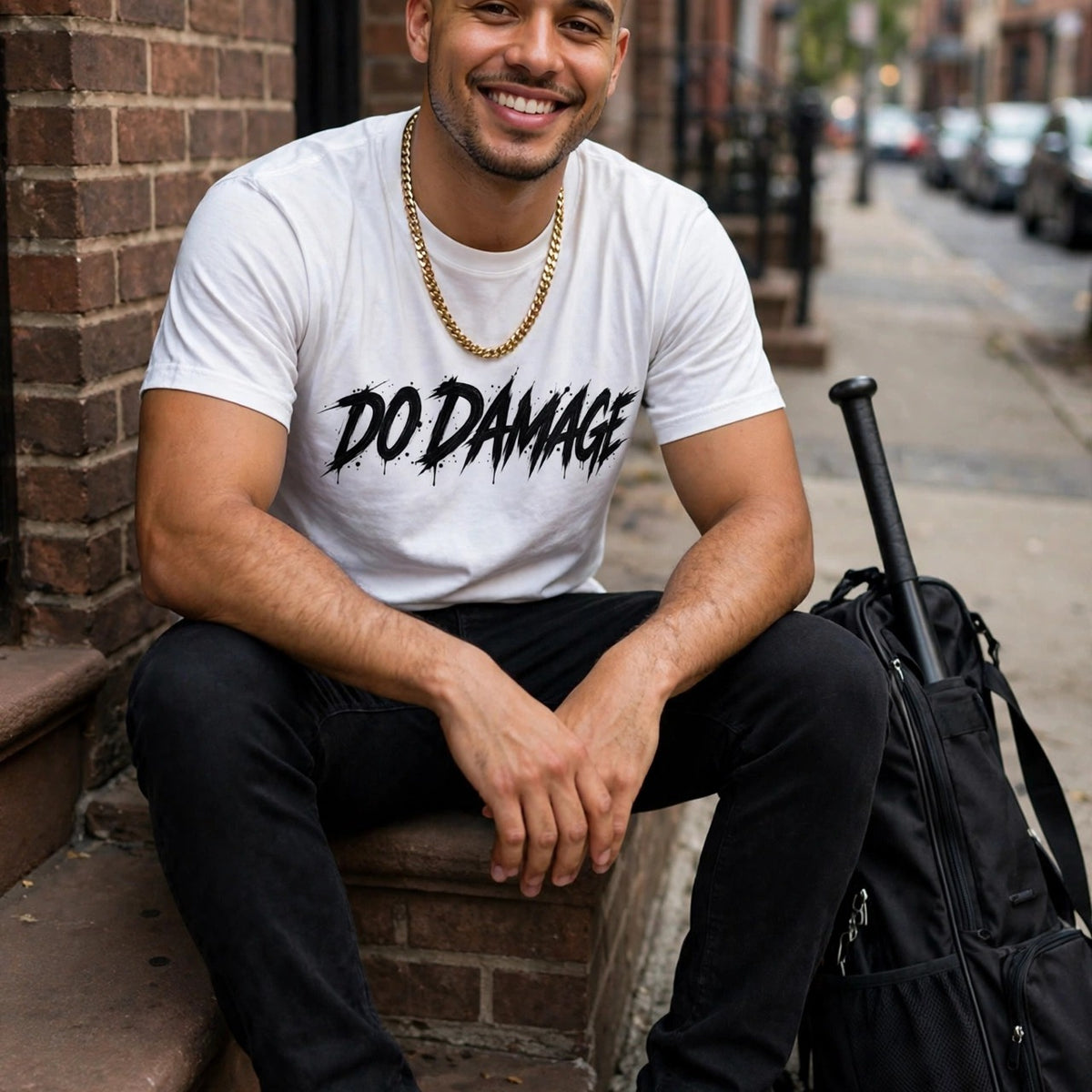 HTB Skull Tee in white, Do Damage front worn on a city stoop